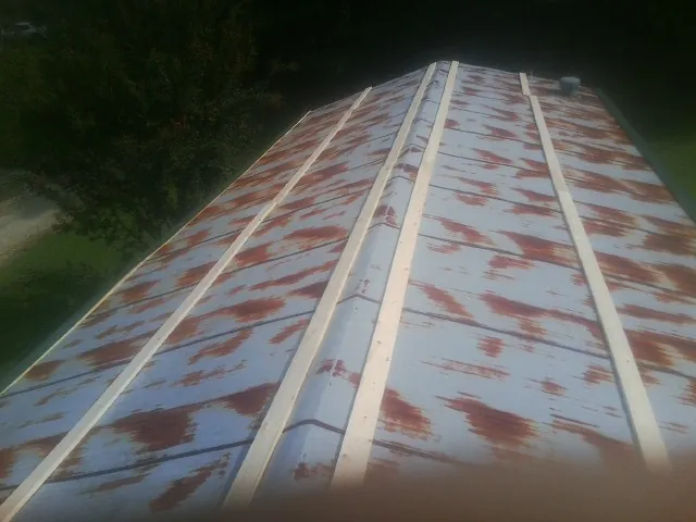 Rusted metal roof panels with new wood purlins before replacement — Storm Damage Roof Repair in Cliffside Park by Roofing Brothers
